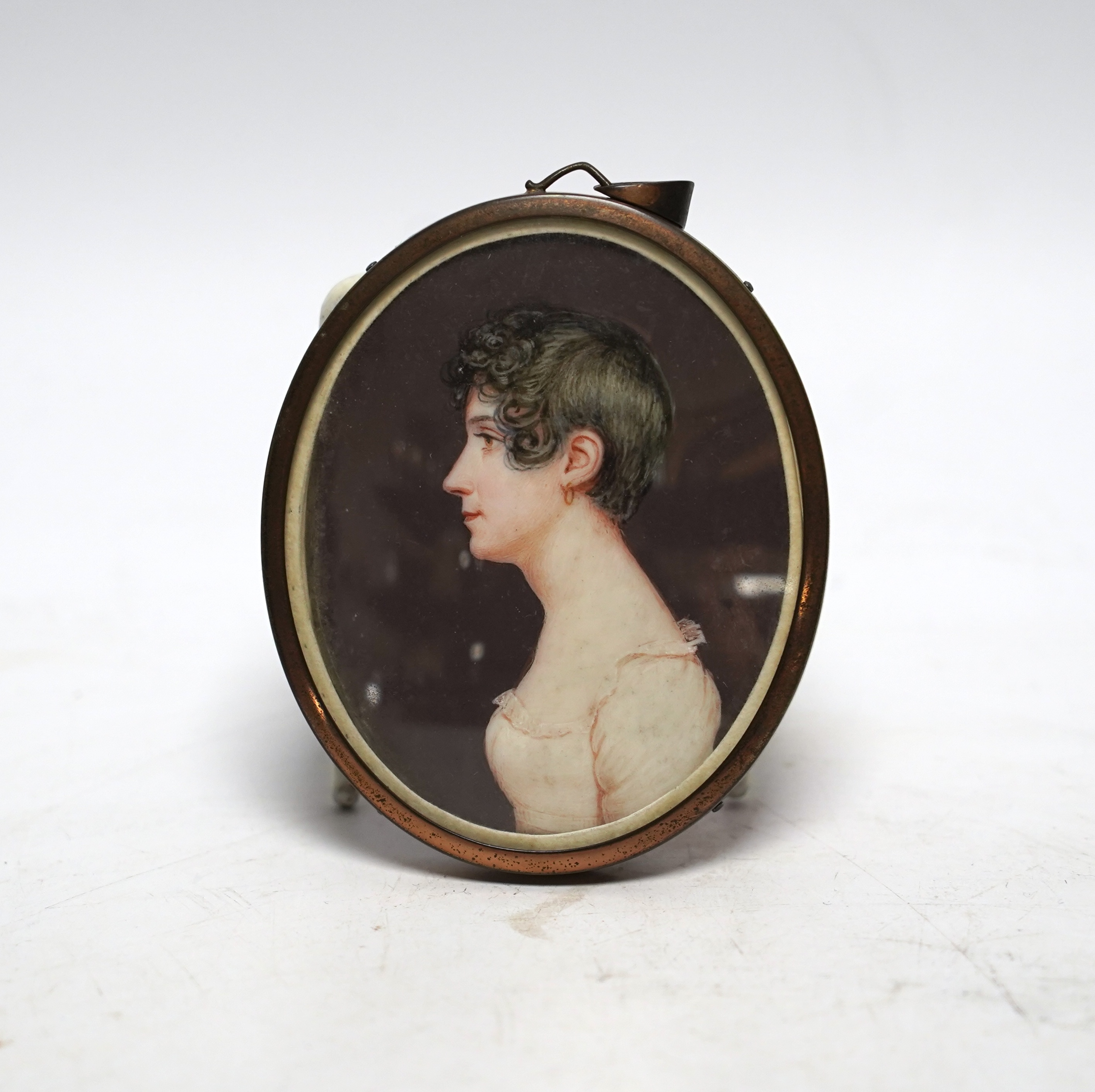 A 19th century oval miniature on ivory portrait of a Regency lady to dexter, 7.5cm high CITES Submission reference E689CNGS